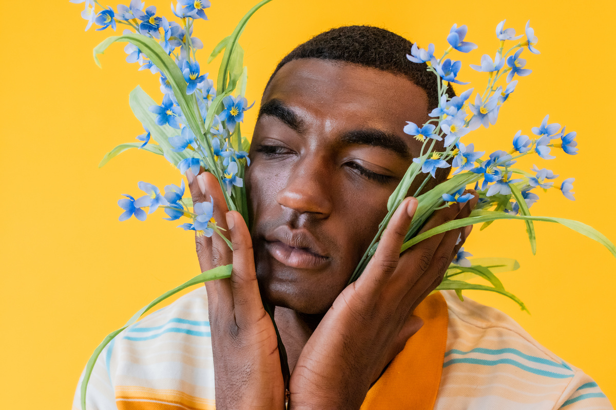 Portrait of a Man with Flowers on Yellow Background